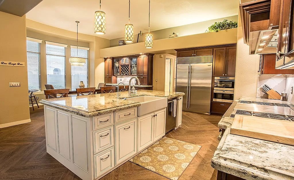 Warm kitchen with granite island and wooden cabinets