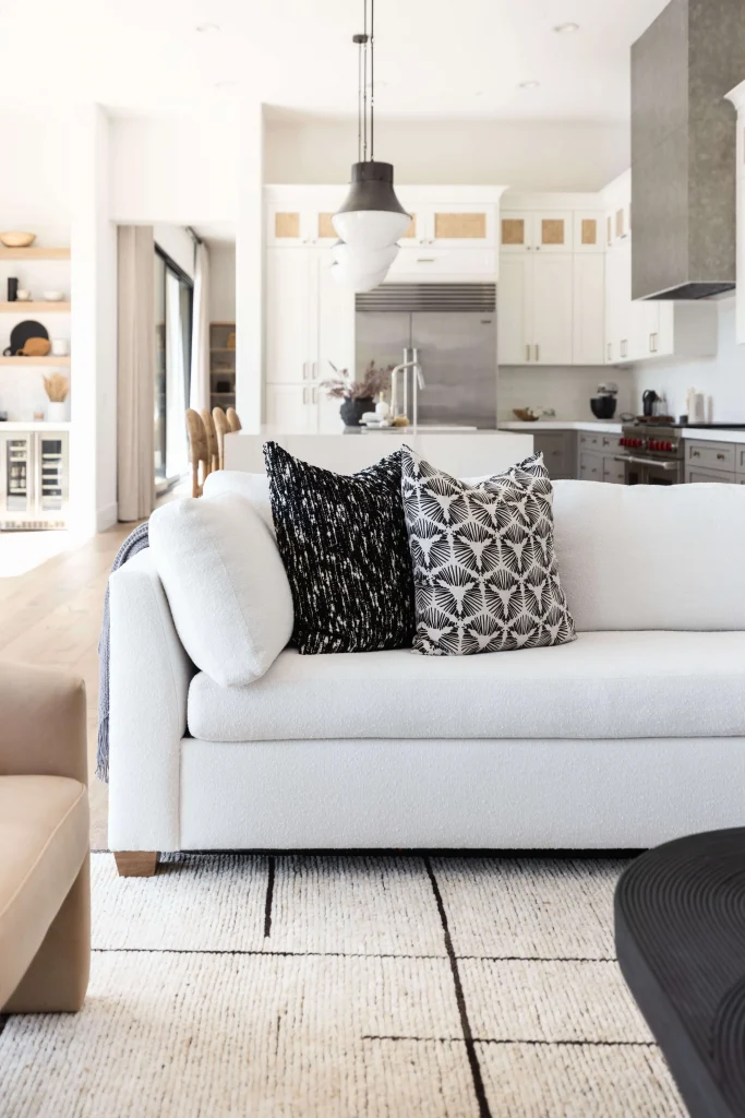 White couch with black and white pillows