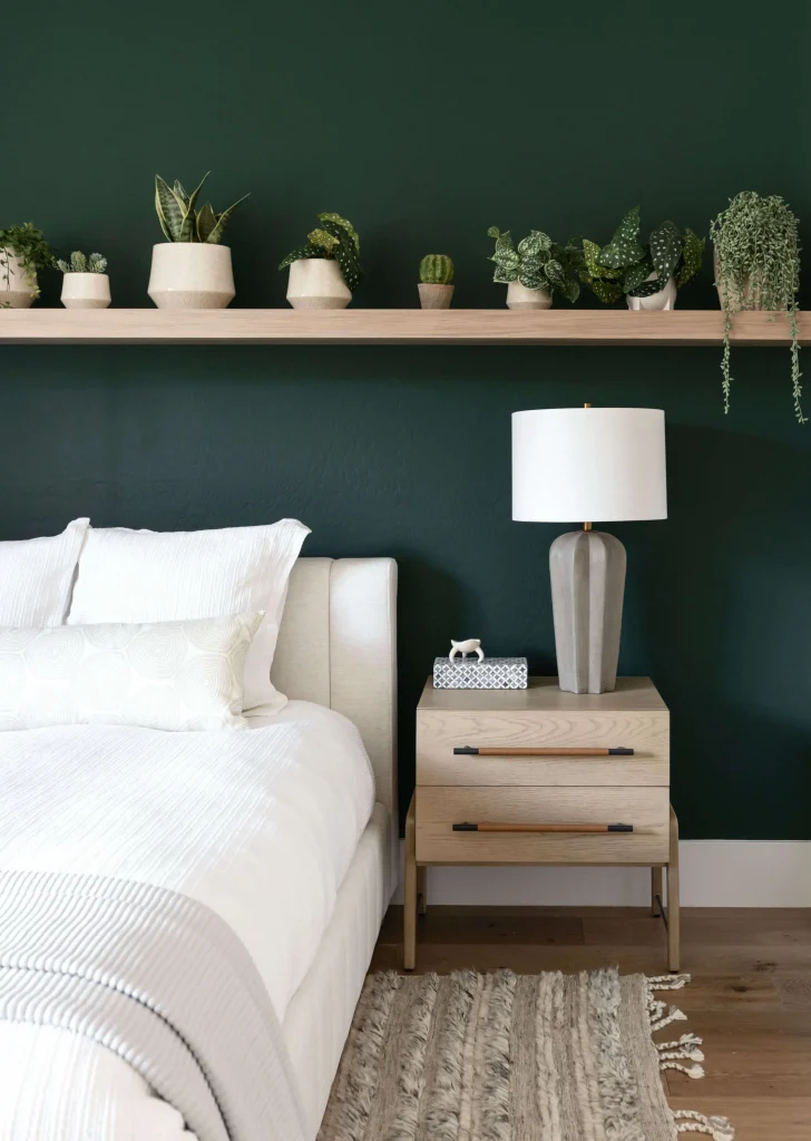 Bedroom with dark green wall and plants