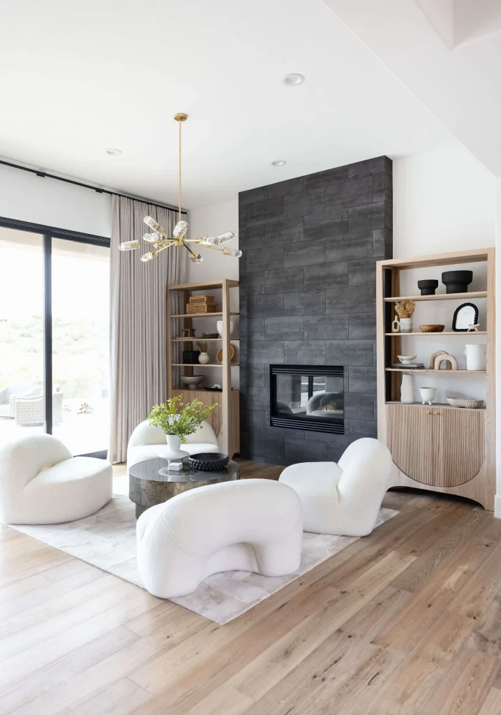 Bright living room with fireplace and chairs
