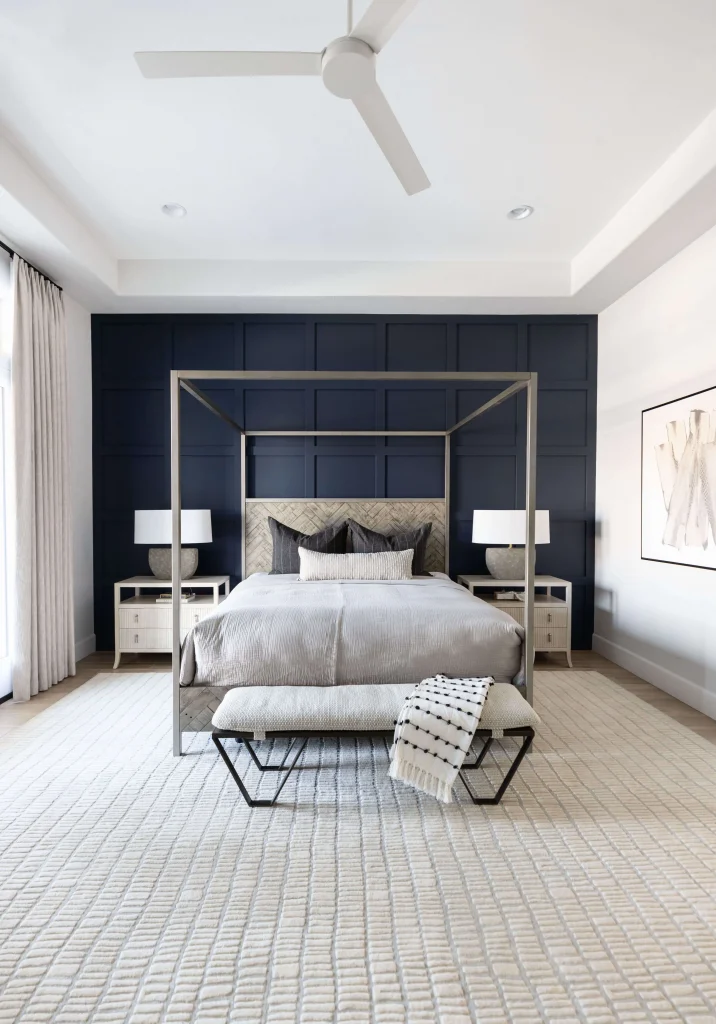 Modern bedroom with canopy bed and navy wall
