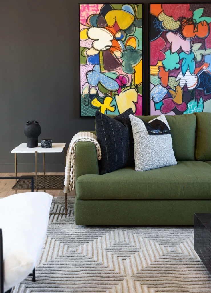 Living room with colorful artwork and green sofa