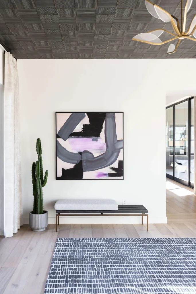 Minimal hallway with abstract artwork and cactus