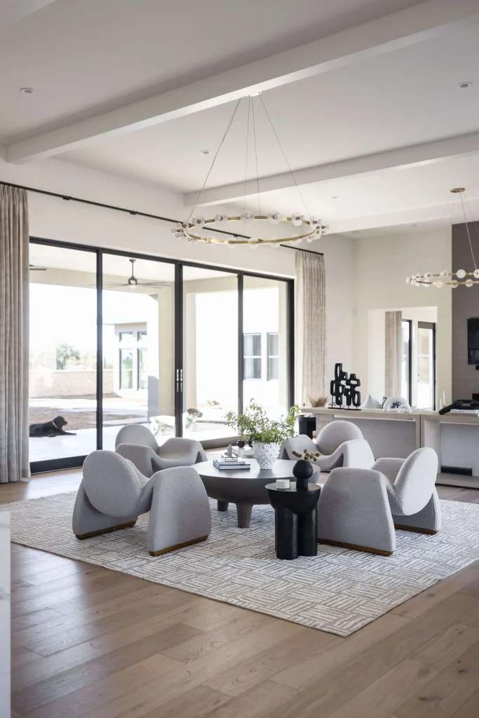 Elegant open-concept lounge with unique circular chairs and statement lighting