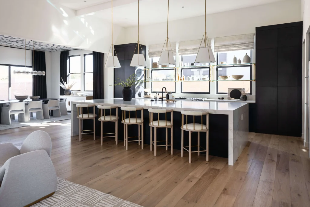 Spacious kitchen with marble island and bar stools