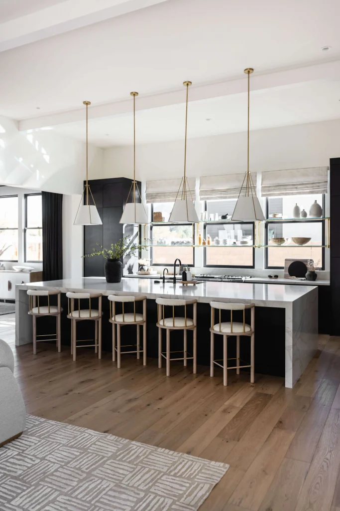 Contemporary kitchen with white island, black accents, and pendant lighting