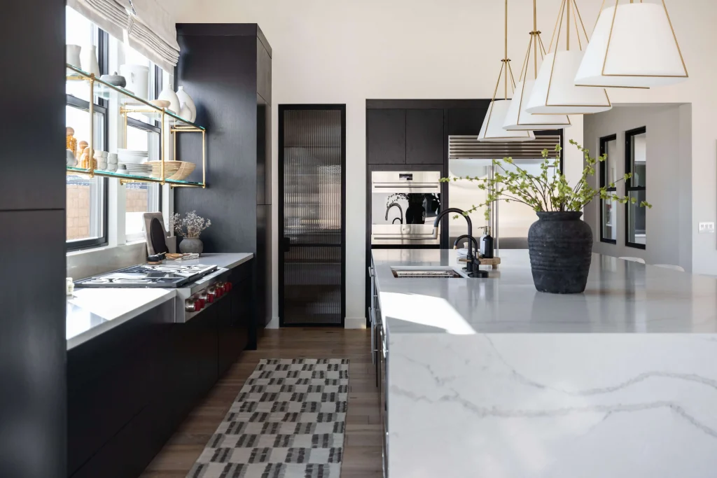 Sleek black kitchen with marble waterfall island