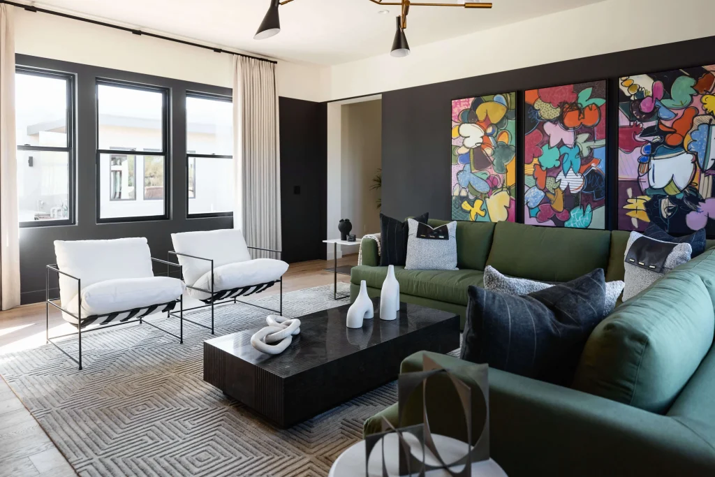 Modern living room with green sofa and colorful wall art