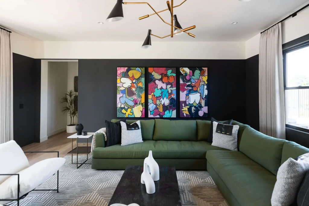Living room with dark accent wall and green sofa set