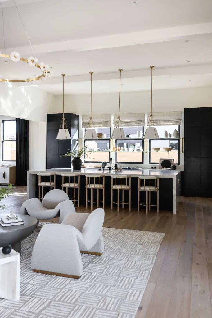 Modern open kitchen with pendant lights and sleek dining area