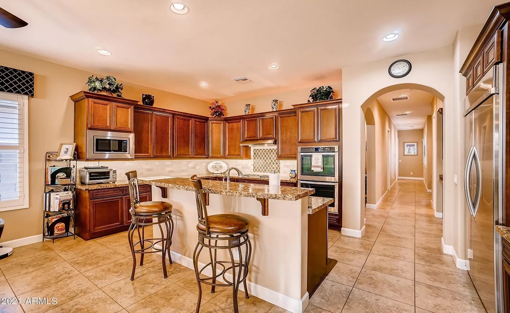Cozy kitchen with granite counters and bar stools