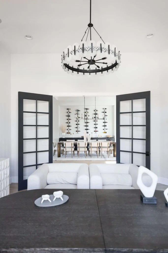 Modern dining room seen through black French doors
