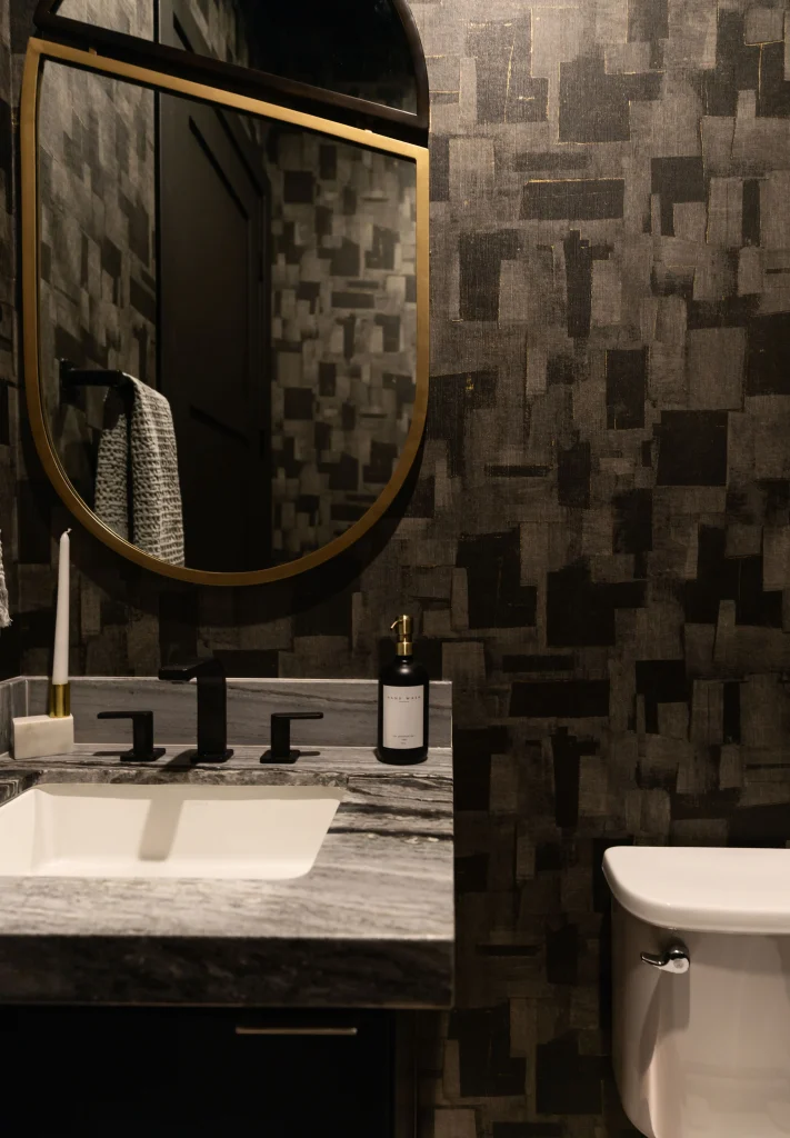 Dark modern bathroom with bold mirror