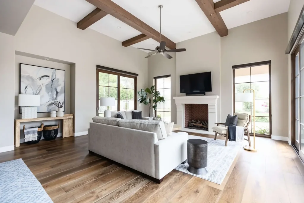 Bright living room with neutral tones and wood beams