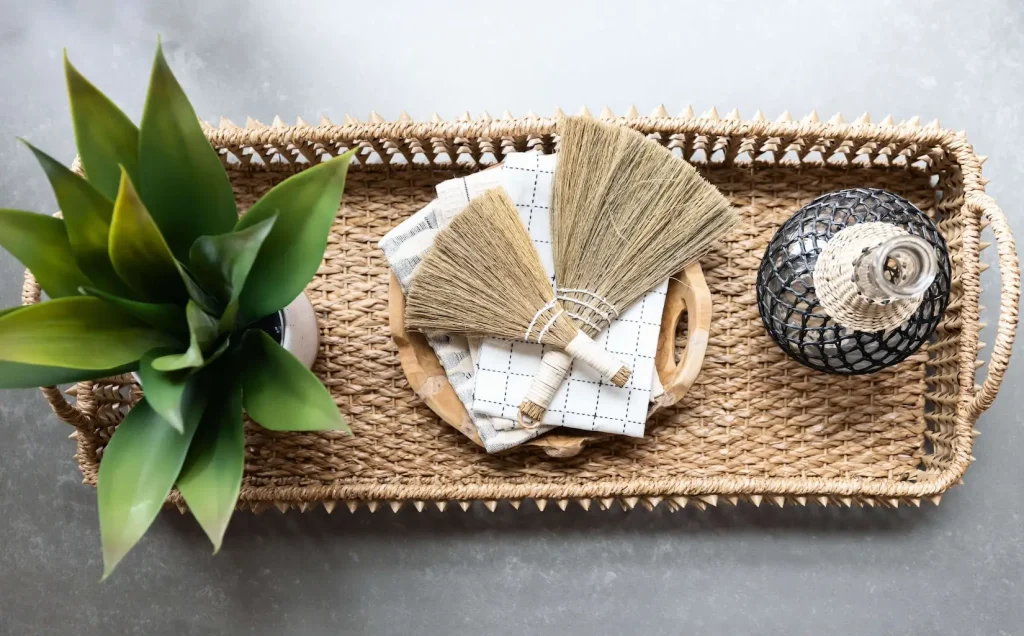 Woven tray with plant, brushes, and glass bottle