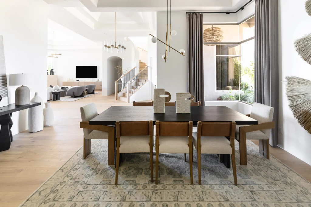 Modern dining room with wooden chairs and gray curtains