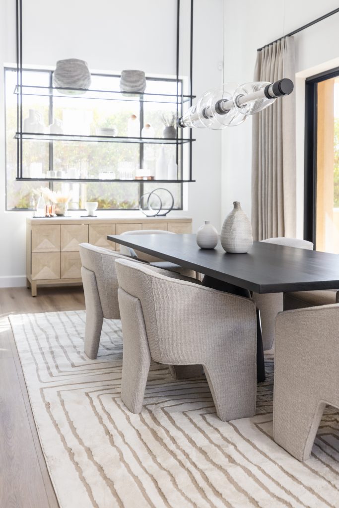Minimal dining room with beige chairs and black table