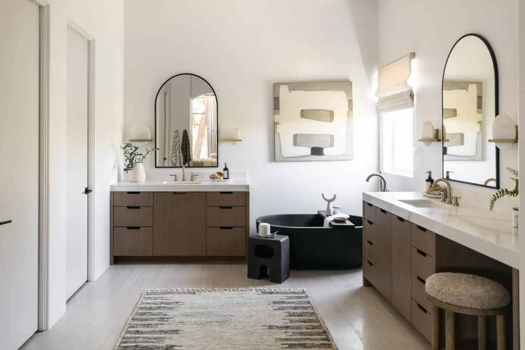 Bathroom with arched mirrors and wood cabinets