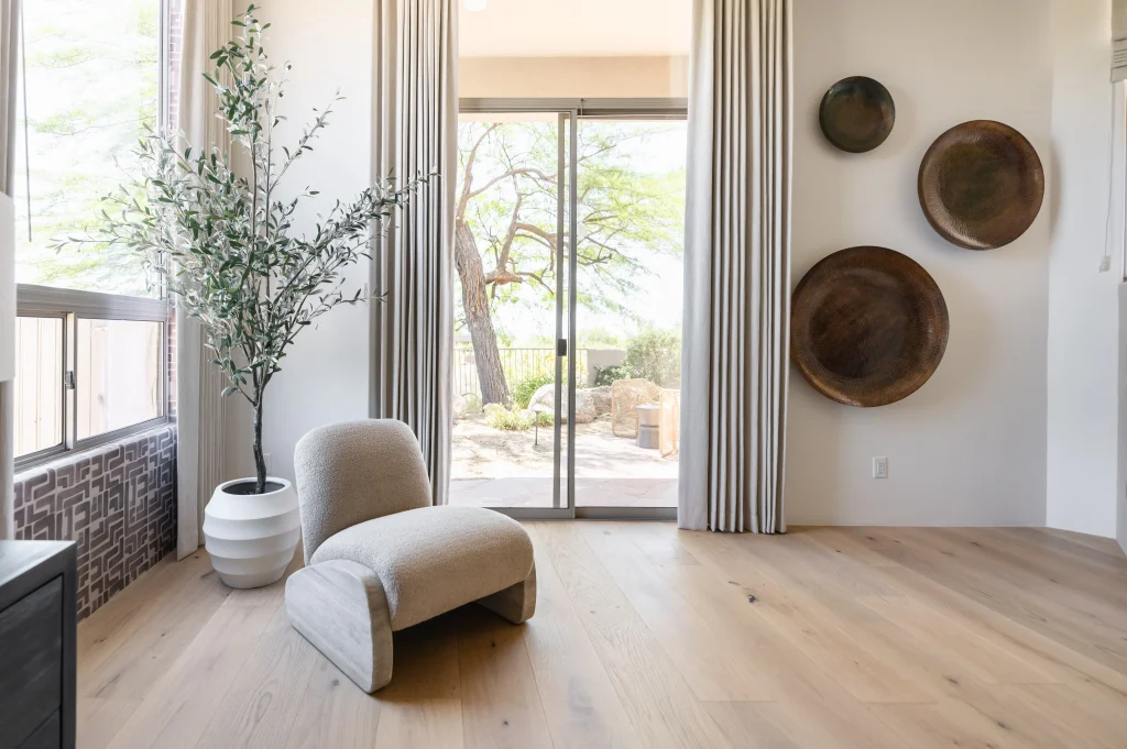 Elegant lounge corner with modern armchair and large windows.