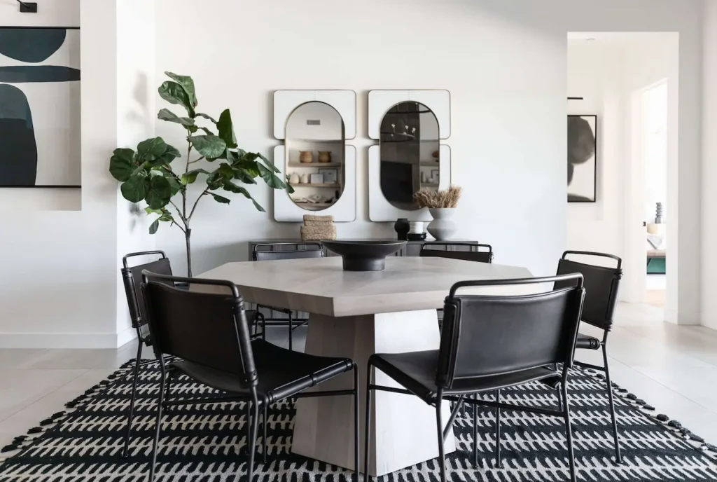 Contemporary dining room with round table and black leather chairs