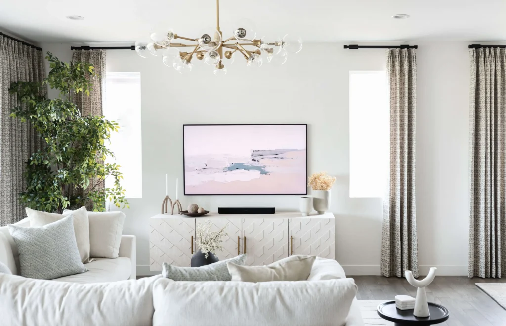 Bright living room with white sofas and art