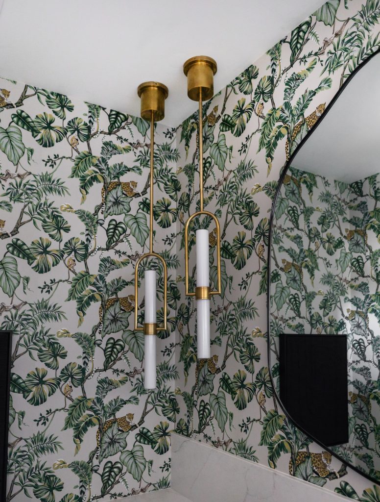 Brass pendant lights with jungle wallpaper