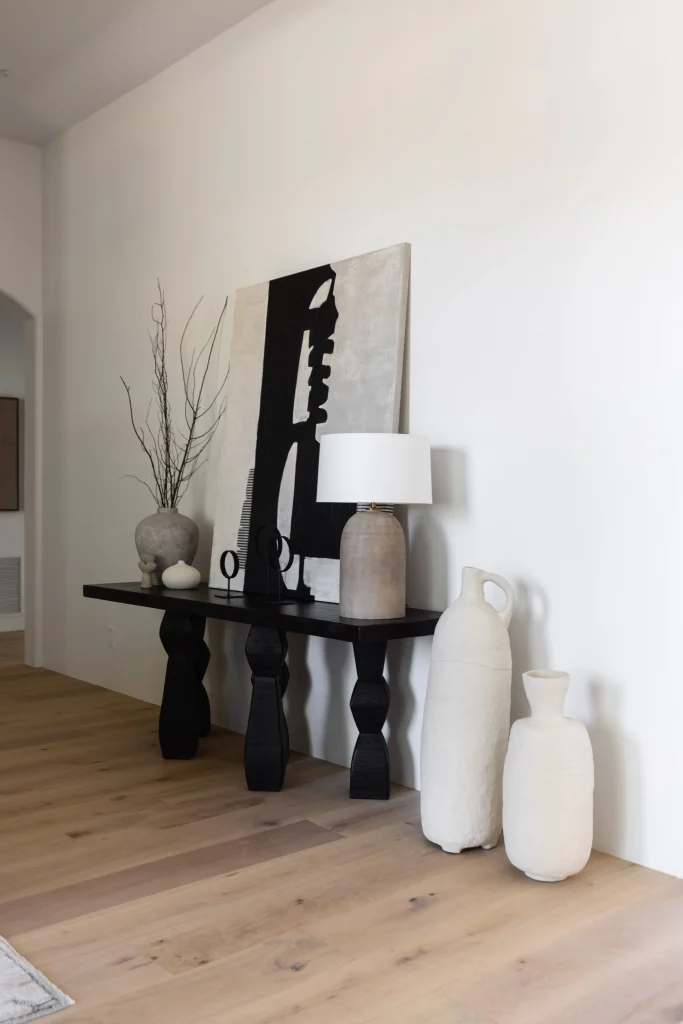 Hallway with black console table and ceramic vases