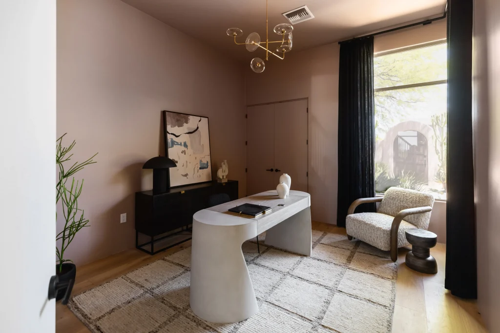 Room with modern lighting and sculptural desk