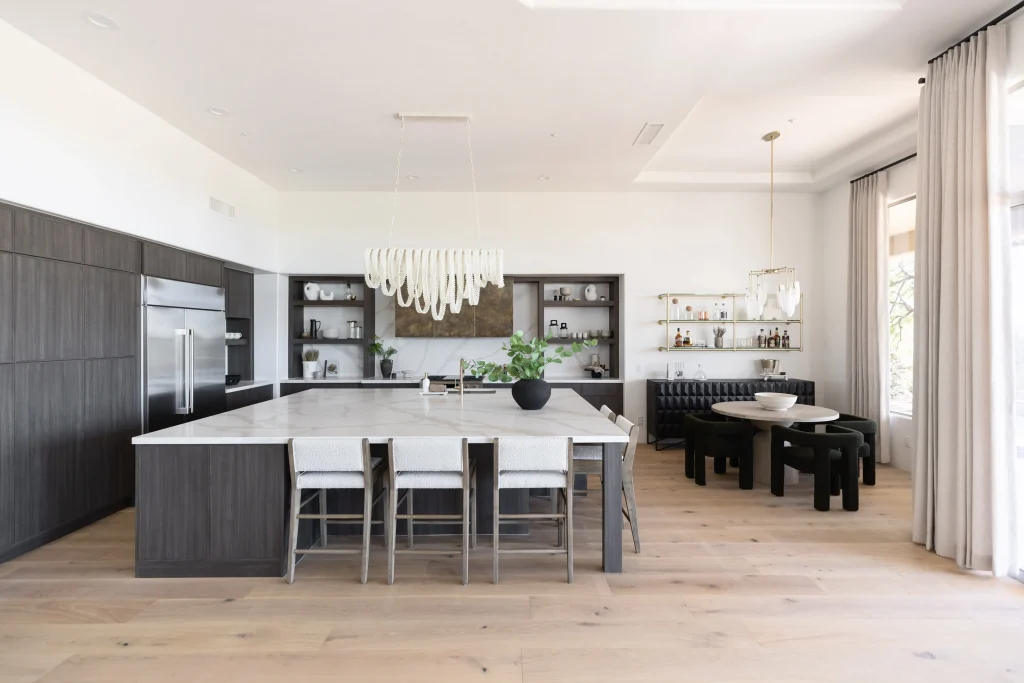 Dining room with modern chandelier and black chairs