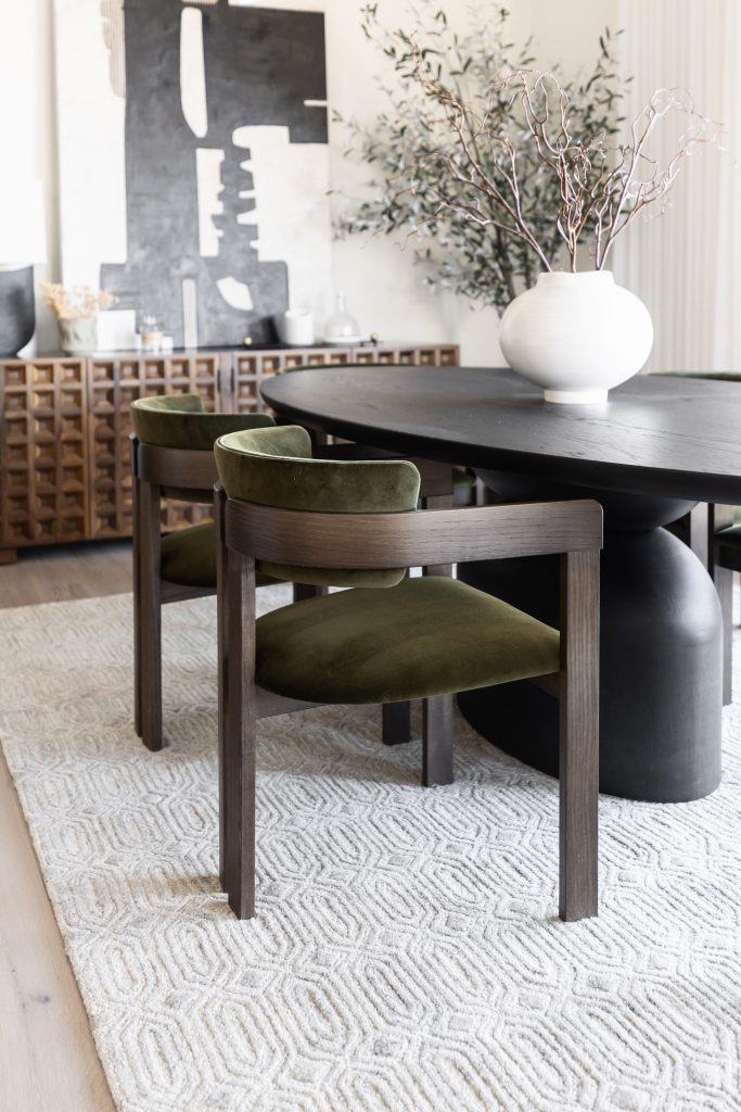Dining area with green velvet chairs