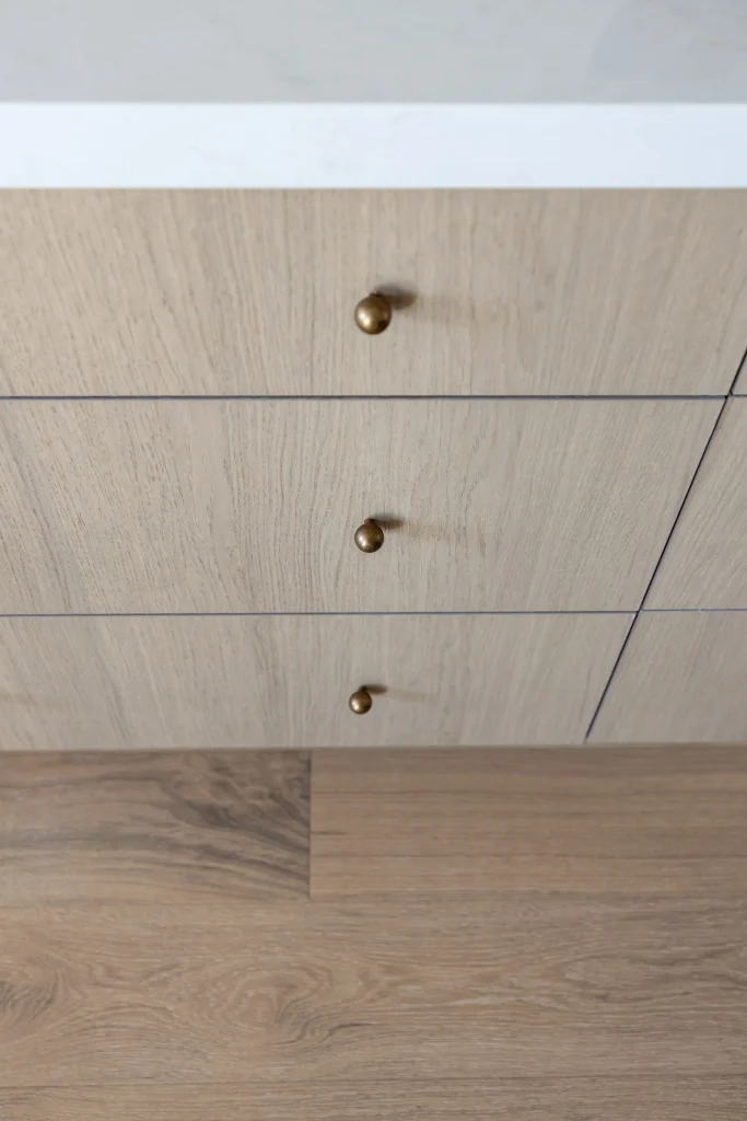 Wooden cabinet drawers with brass knobs