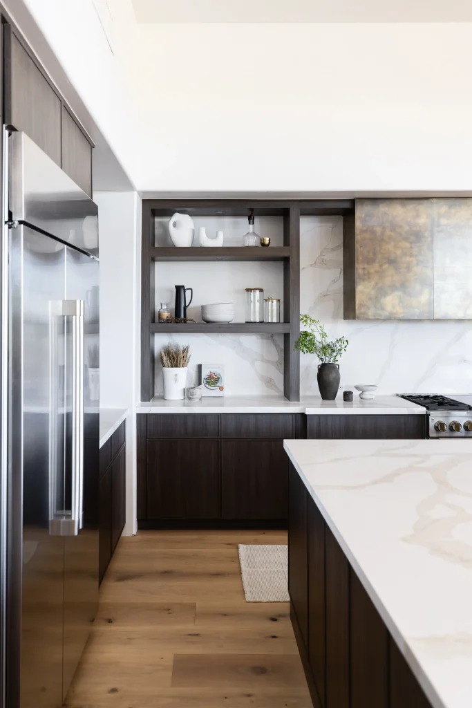 Modern kitchen with dark cabinetry and marble countertop
