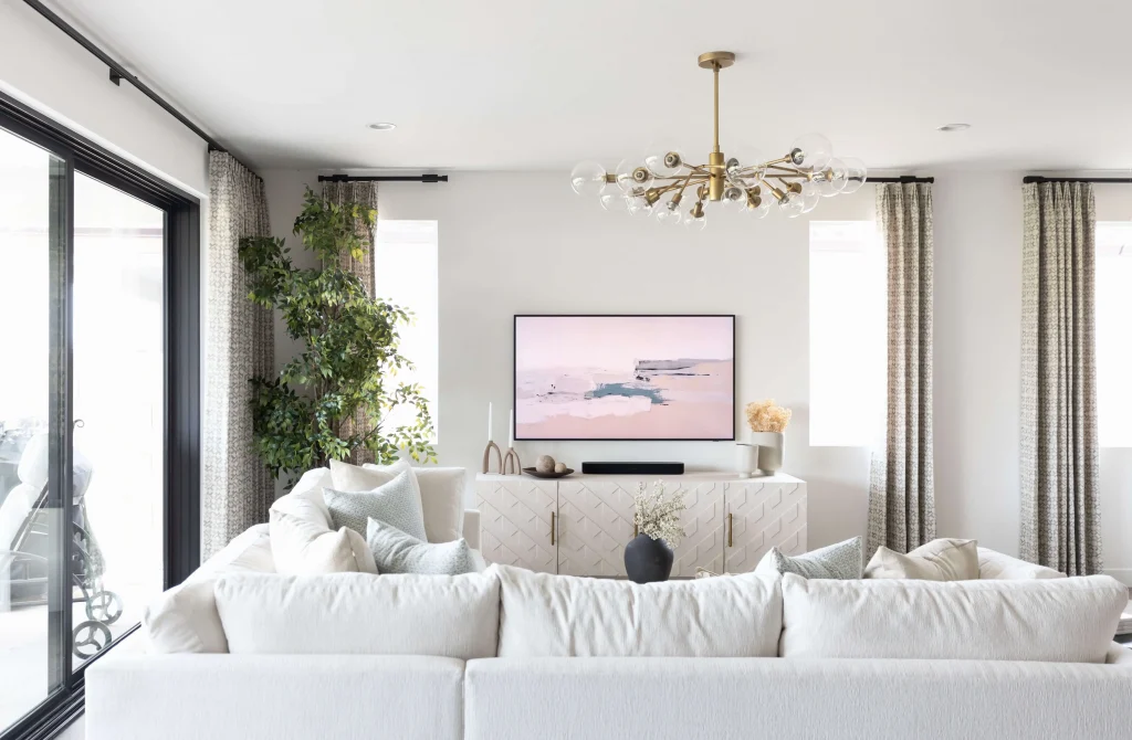 Bright living room with white sofa and chandelier