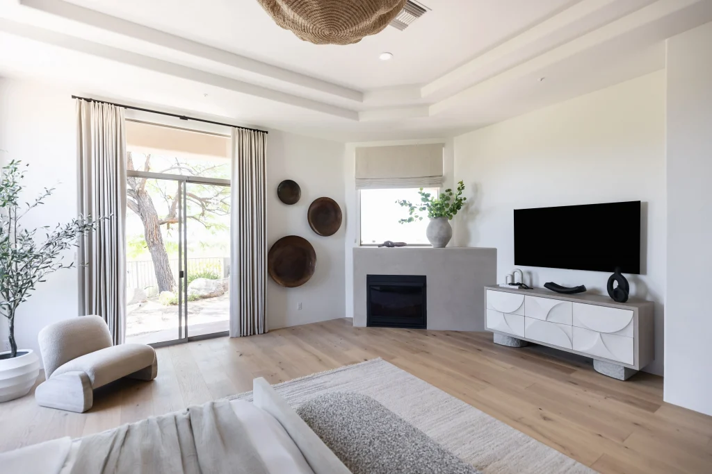 Modern beroom with TV, neutral decor and large windows