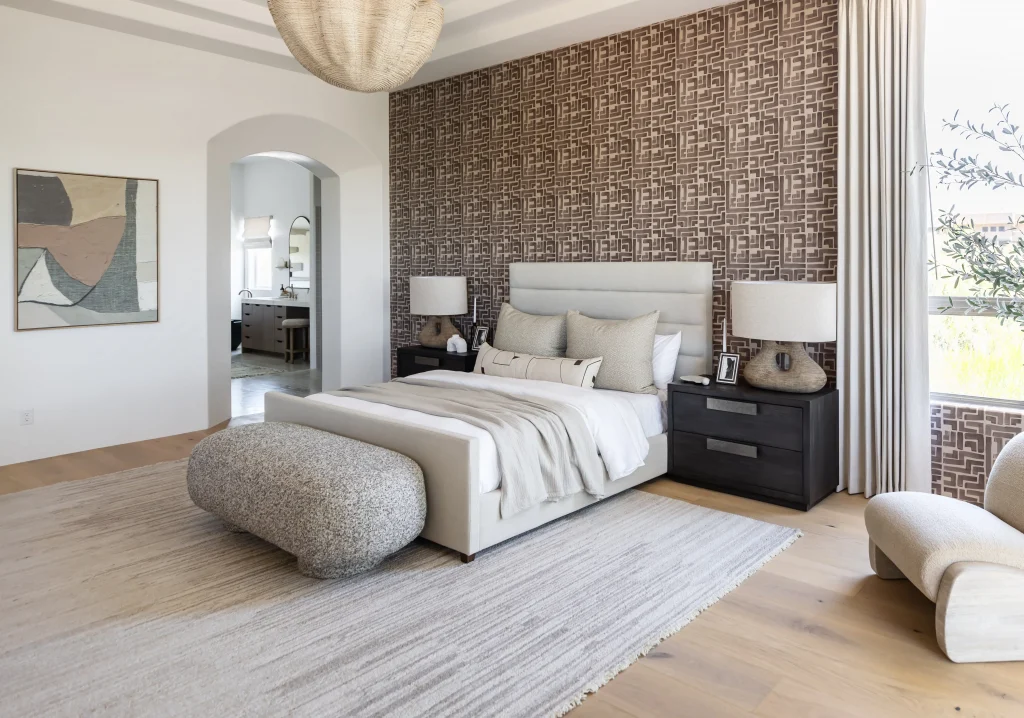 Stylish bedroom with accent wallpaper and curved bench