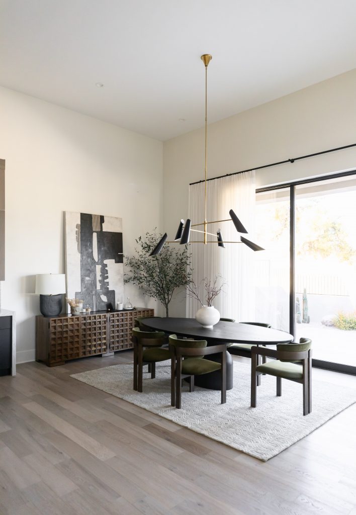 Dining room with black table and chandelier