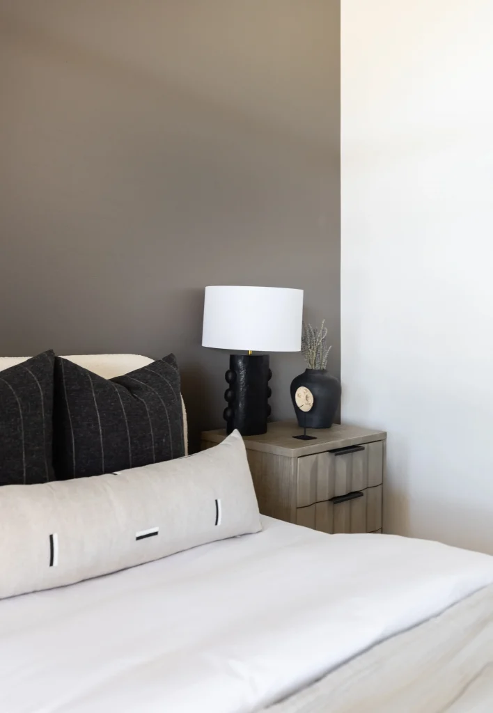 Bedroom corner with neutral bedding and modern decor