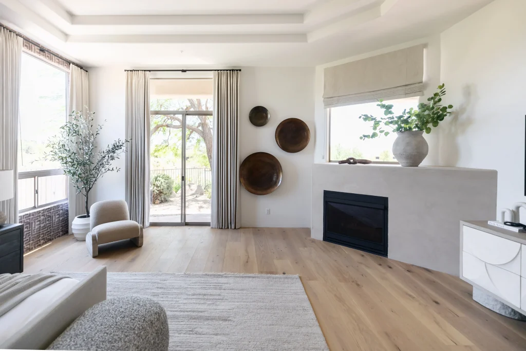 Open living room with fireplace and tall windows
