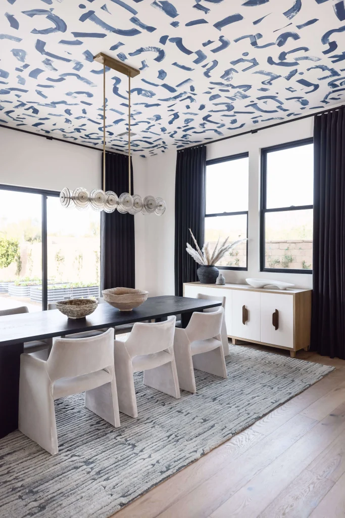 Bold dining room with artistic ceiling and modern furniture