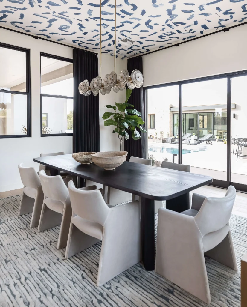 Modern dining area with dark wood table and patterned ceiling