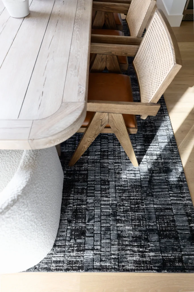 Dining chairs on dark textured rug
