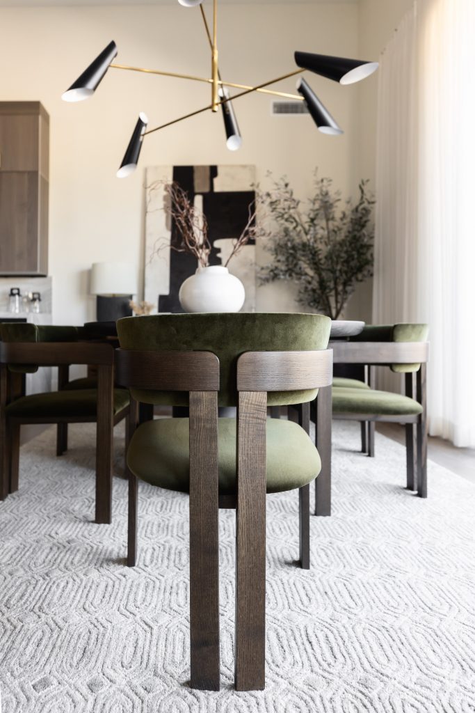 Close-up of dining chairs with olive cushions