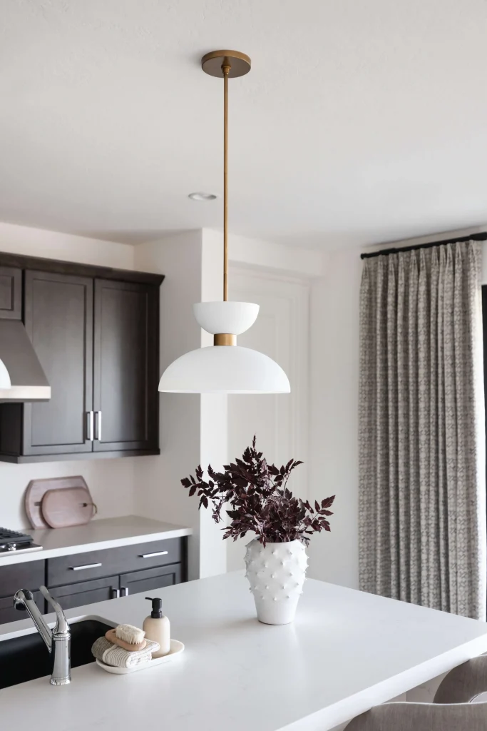 Kitchen with white island and dark cabinets