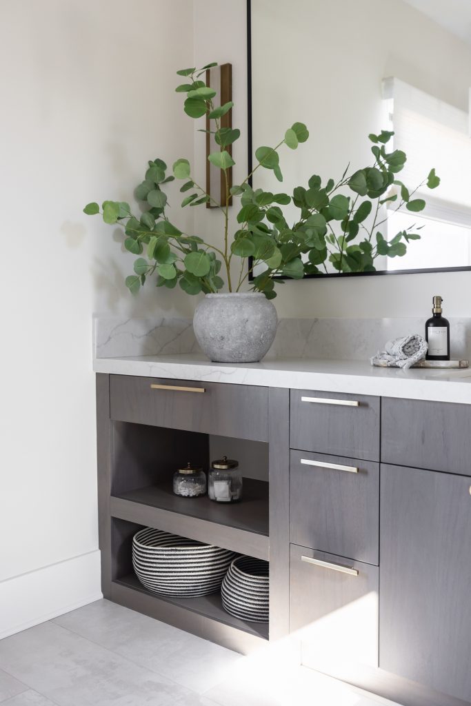 Bathroom counter with greenery and striped baskets