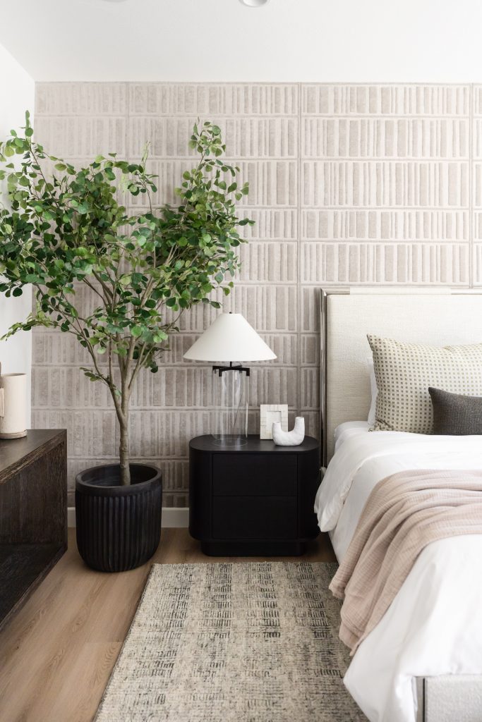 Bedroom with textured wall and green plant