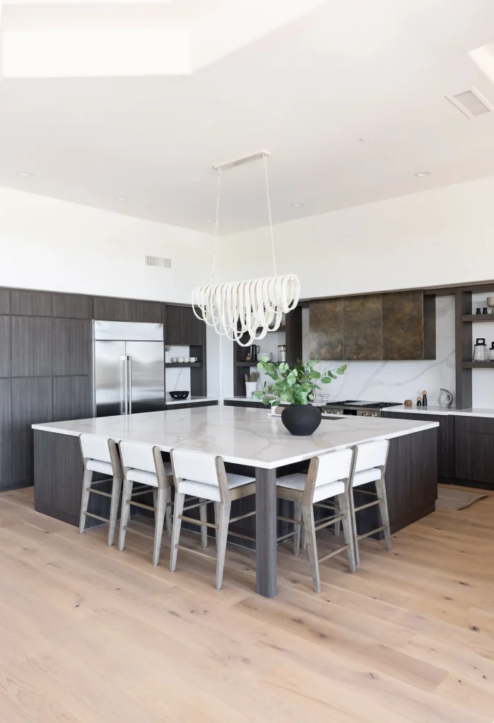 Kitchen with oversized marble island and white pendant light