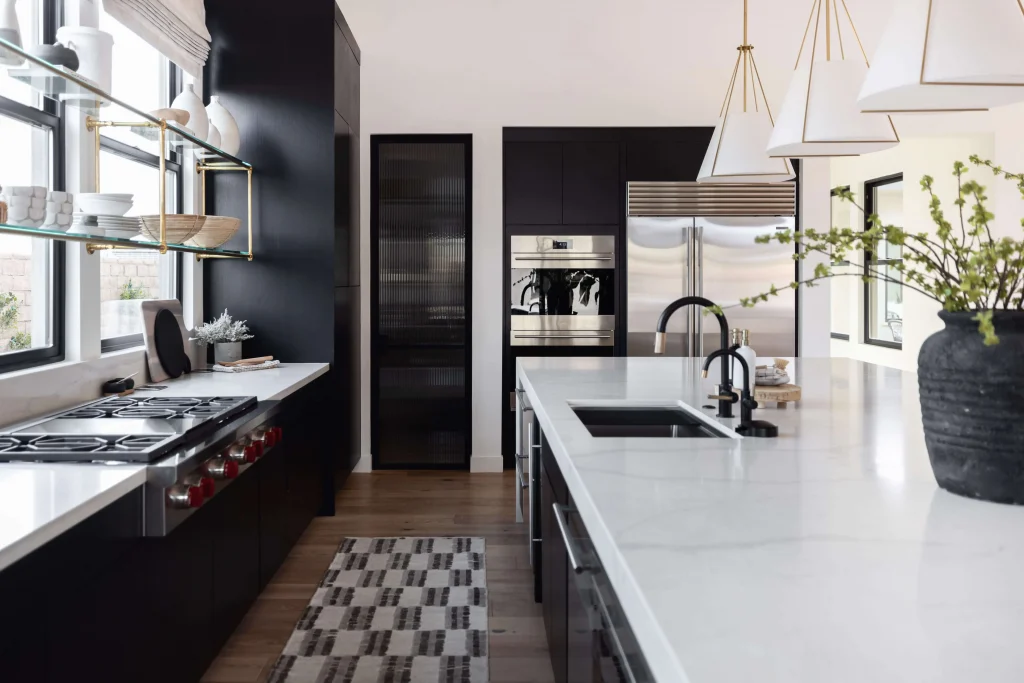 Modern kitchen with black cabinetry, open shelving, and white countertops