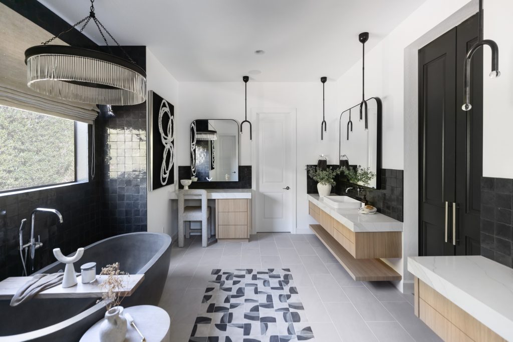 Sleek modern bathroom with black tub and vanity