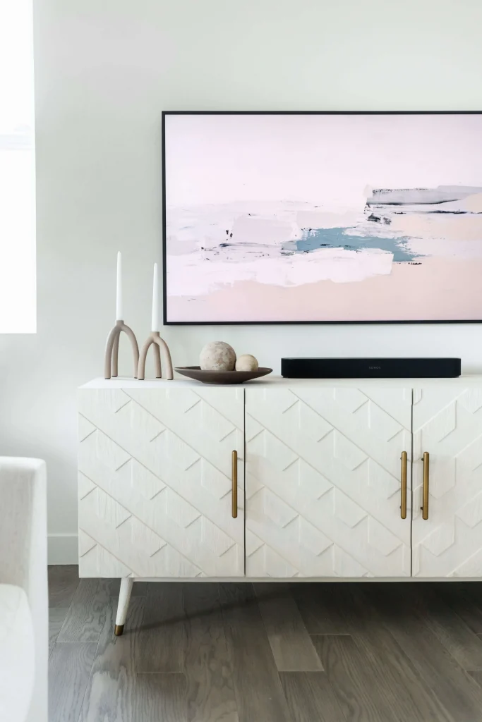 White cabinet with candles and wall art