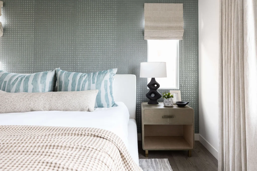 Stylish bedroom with soft bedding and nightstand